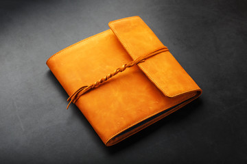 The album cover is made of brown genuine leather, handmade on a black background.