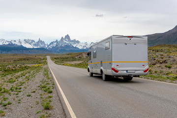 Mobile home truck traveling on the road in Patagonia with the Mount Fitz Roy on the background