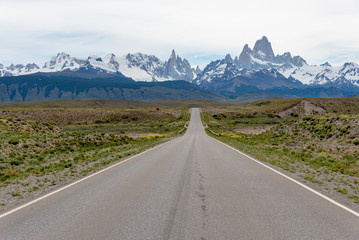 Empty road with the Mount Fitz Roy on the background. Patagonia, Argentina
