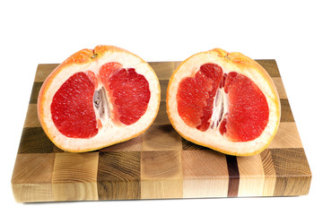 Sliced grapefruit  on a wooden  cutting board.  Isolated. Healthy food.