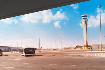 Airport infrastructure - a passenger bus and a control tower