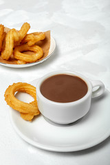 Cup of chocolate sauce with churros