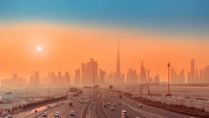 Fototapeten Highway Road und Dubai-Stadtbild-Skyline bei Sonnenuntergang. Transport und Reisen in den Vereinigten Arabischen Emiraten Konzept © EdNurg