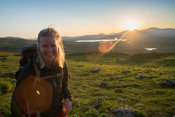 Open landscape of Midnight sun in Lapland Northern Sweden, Europe. Happy Female Hiker enjoy the...