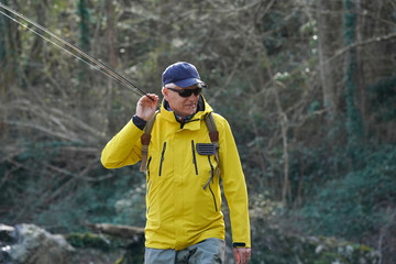 fly fisherman in river in winter