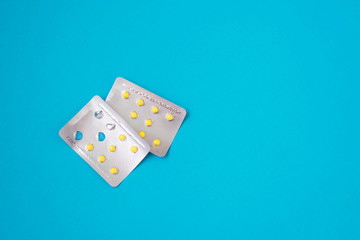 Various medicines on a blue background. Copy space. Medicine flat lay. Medications for pregnant women. Folic acid.