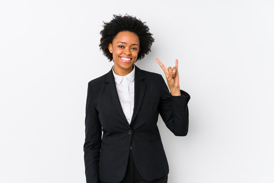 Middle aged african american business  woman against a white background isolated showing a horns gesture as a revolution concept.