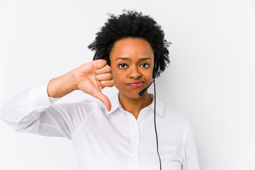 Young african american telemarketer woman isolated showing a dislike gesture, thumbs down....