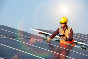 Solar cell power engineer technician checks the maintenance of the solar panels.