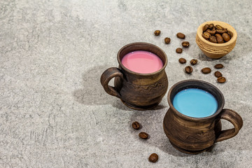 Trendy drink blue and pink latte. Lavender or spirulina and rose, beetroot or raspberry coffee. Stone concrete background