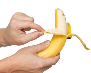 Banana in male hands on a white background
