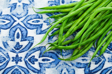 Green beans on blue and white background. Top view. Copy space.