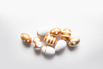 Easter golden eggs pattern on a white background with place for text.