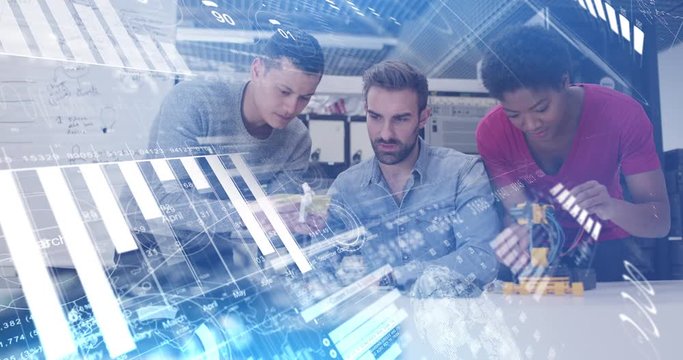 Digital composite of tech start up team working on robot with graphics moving over the screen
