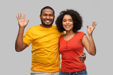 Fototapeta premium relationships and people concept - happy african american couple hugging over grey background