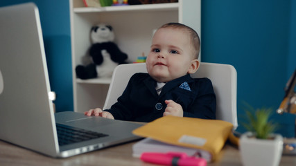 Boy little child businessman boss in office use laptop look at camera sitting play creative boy happy job kid work child computer education young suit cute career confident slow motion.