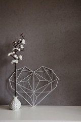 Stylish still life inside apartment. Elegant heart with notes on the background of concrete wall in the interior. Minimalism. Home Decor