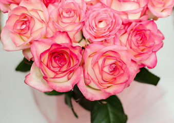 bouquet with delicate fragrant rose flowers on a wooden background, a gift for the holiday