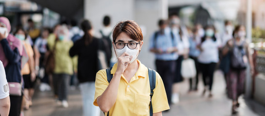 young Asian woman wearing protection mask against Novel coronavirus (2019-nCoV) or Wuhan...