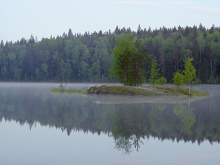 Sunrise and fog in a beautiful lake in Karelia