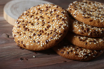 cookies sprinkled with fragrant sesame seeds on a wooden table background