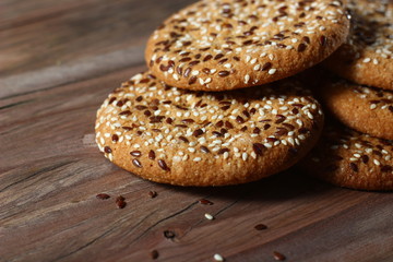 cookies sprinkled with fragrant sesame seeds on a wooden table background