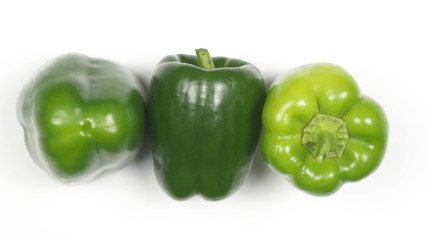 three green peppers on white background.