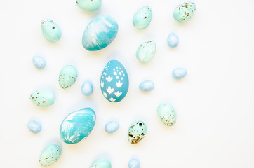 Set of blue festive Easter eggs on white background. Top view Easter concept