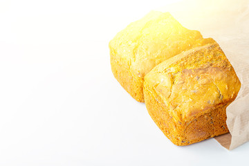Two loaves of whole-grain bread on white background. Freshly baked homemade square bread. Organic and vegetarian food concept. Copy space for text,