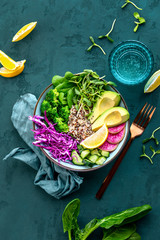 Vegan quinoa avocado and sprouts bowl, view from above