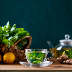 Fresh mint herbal tea in a glass cup, front view