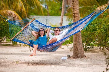 Family on summer vacation relaxing in hammock