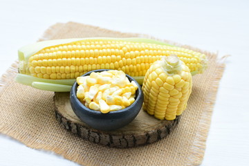 fresh organic corn in leaf, shelled and in pieces