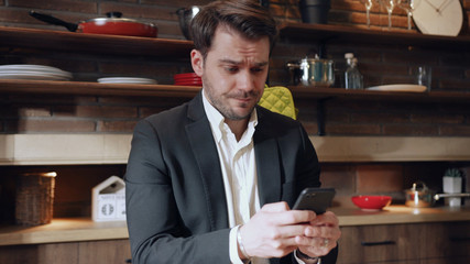 Slow motion young businessman use phone sad work in the morning at kitchen computer business home technology work confident male documents internet slow motion