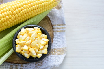 fresh organic corn in leaf, shelled and in pieces