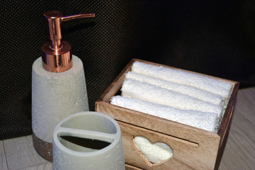 Bathroom accessories on a brown background. Soap and a white towel for hygiene.