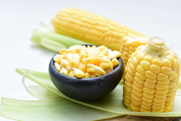 fresh organic corn in leaf, shelled and in pieces