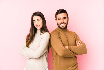 Fototapeta premium Young caucasian couple isolated who feels confident, crossing arms with determination.