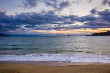Nha Trang, Vietnam sunrise featuring south China Sea, East Sea, distant islands and a ship wreck in the foreground beach