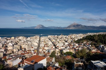 Cityscape of Patras city in Greece with generic architecture, streets and hills in background