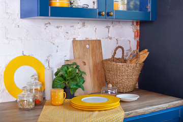 Kitchen utensils, concept of home decor kitchen. Modern kitchen with cooking utensils and clean dishware. Kitchen tools, cutting boards on table against white brick wall. dinning interior. rustic 