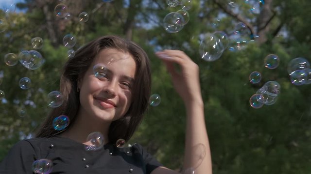 Poses in bubbles. Beautiful girl in soap bubbles.