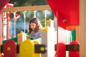 Little kid on playground, children's slide