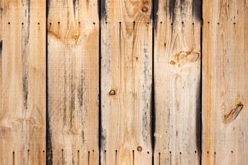 A close up of barn wood planks nailed on a wall.