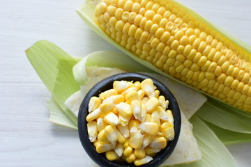 fresh organic corn in leaf, shelled and in pieces
