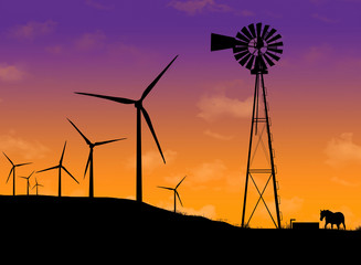 Wind turbines and an old water windmill are silhouetted at sunset as a horse comes to the old windmill for a drink of water.