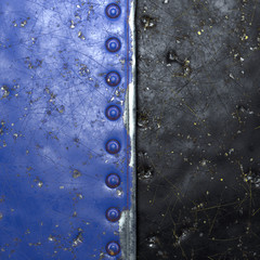 Painted blue metal with rivets on black metal background. 3d