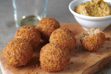 Bitterballen are a Dutch meat-based snack, made by making a very thick stew thickened with roux and beef stock and generously loaded with meat.
