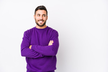 Young caucasian man against a white background isolated smiling confident with crossed arms.