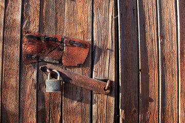 Old wooden door with padlock